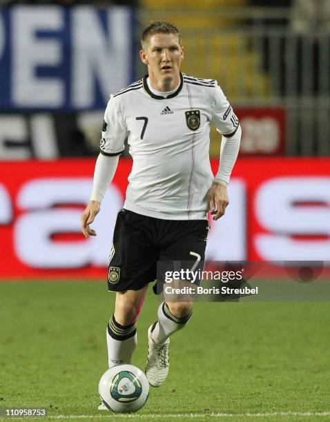 Bastian Schweinsteiger of Germany runs with the ball during the EURO 2012 Group A qualifier match between Germany and Kazakhstan at...