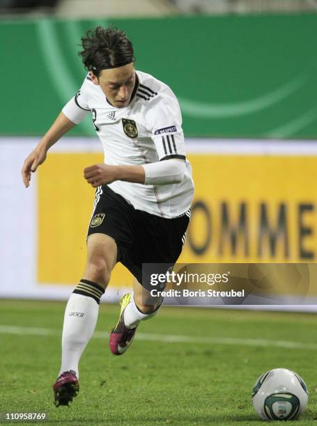 Mesut Oezil of Germany runs with the ball during the EURO 2012 Group A qualifier match between Germany and Kazakhstan at Fritz-Walter-Stadium on...