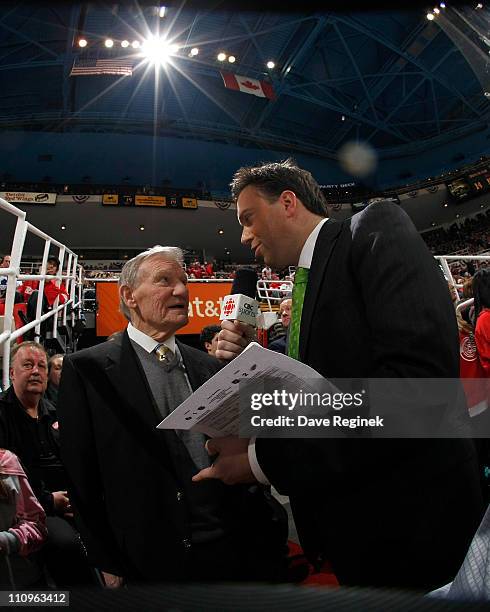 Elliotte Friedman of CBC Sports Canada, interviews former Red Wing Jonny Wilson during an NHL game between the Toronto Maple Leafs and the Detroit...