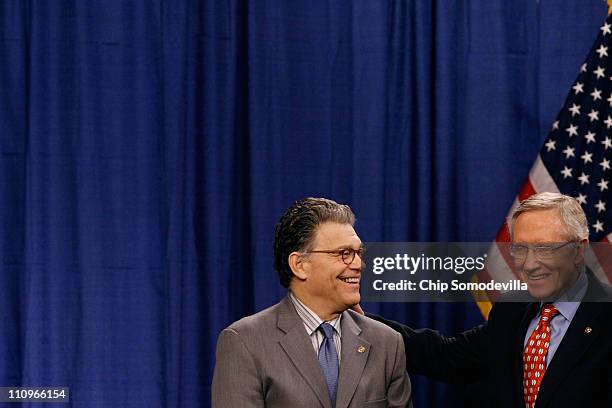 Sen. Al Franken and Senate Majority Leader Harry Reid share a laugh during a rally in support of Social Security in the Dirksen Senate Office...
