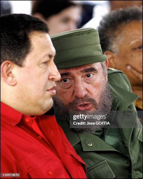 Cuban President Fidel Castro and Hugo Chavez President of Venezuela talk as they sign agreement on culture affairs between both countries in Havana,...