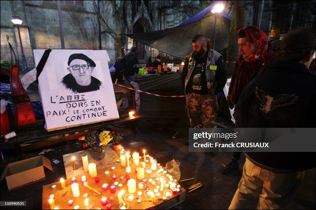 Homeless of the Lille camp of the Children of Don Quixote "and passers make a final tribute to Abbe Pierre by collecte or submitte a candle at the foot of his portrait in Lille, France on January 25th, 2007