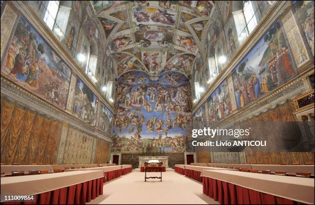 Newly-installed tables stand under Michaelangelo's frescoes in the Vatican's Sistine Chapel where Conclave of Cardinals will be hosted to pick the...