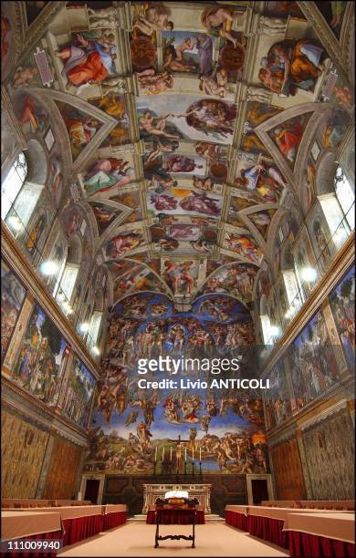 Newly-installed tables stand under Michaelangelo's frescoes in the Vatican's Sistine Chapel where Conclave of Cardinals will be hosted to pick the...
