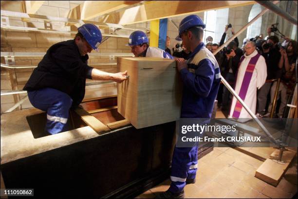 Employees placing the urn in the tomb in Loches, France on April 2nd, 2005.