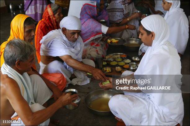 Shravana Belgola, meal of Digambara Jain nuns - They collect in their palms the food offered by devotees in India in November , 2004.