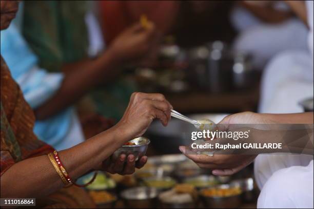 Shravana Belgola, meal of Digambara Jain nuns - They collect in their palms the food offered by devotees in India in November , 2004.