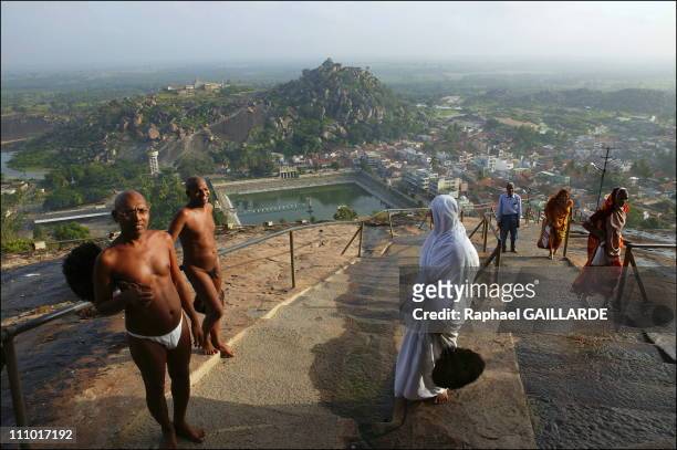 Shravana Belgola, Indragiri hill, Digambara monks and a nun walking up the stairs leading to the temples in India in November , 2004.