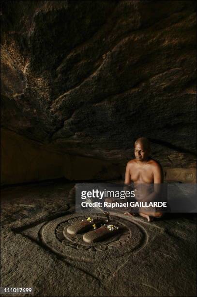 Shravana Belgola, Chandragiri mountain, Digambara monk meditating in Bhadrabahu cave.In front of him are the holy footprints of Bhadrabahu carved out...
