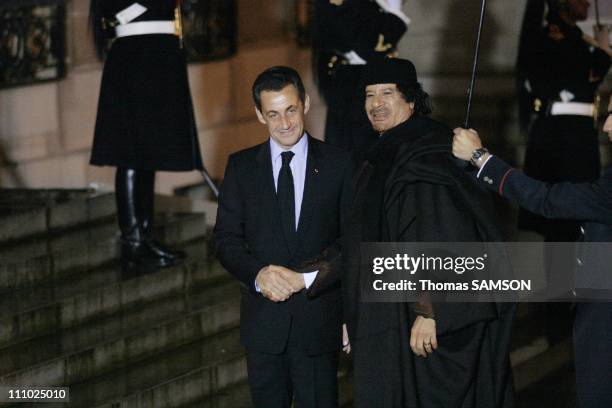 Mouammar Kadhafi and French President Nicolas Sarkozy arriving for a dinner at the Elysee Palace in Orly, France on December 10th, 2007.