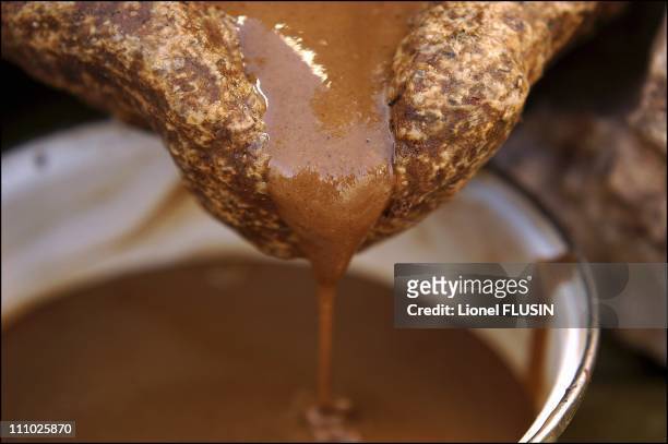 Production of argan oil in the Essaouira area of Morocco - The argan almond paste is mixed with water then pressed to obtain oil in Essaouira on...