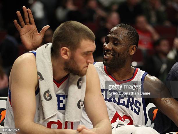 Elton Brand of the Philadelphia 76ers slaps teammate Spencer Hawes on the back at the end of a win over the Chicago Bulls at the United Center on...