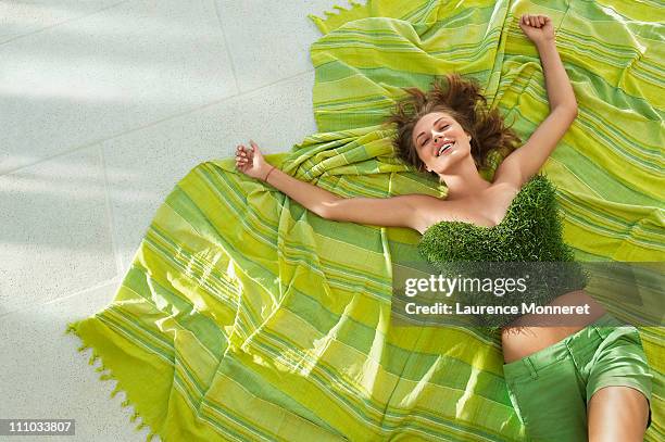 slim girl relaxing with a fresh grass top - khaki shorts stock pictures, royalty-free photos & images