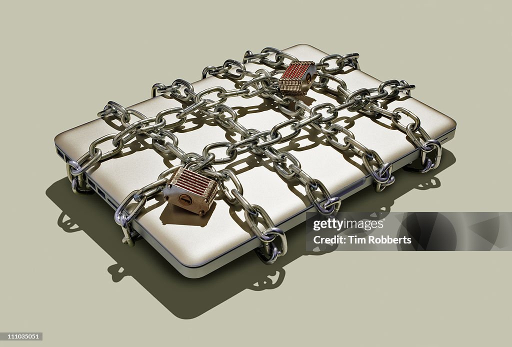 Laptop with chains and padlocks.