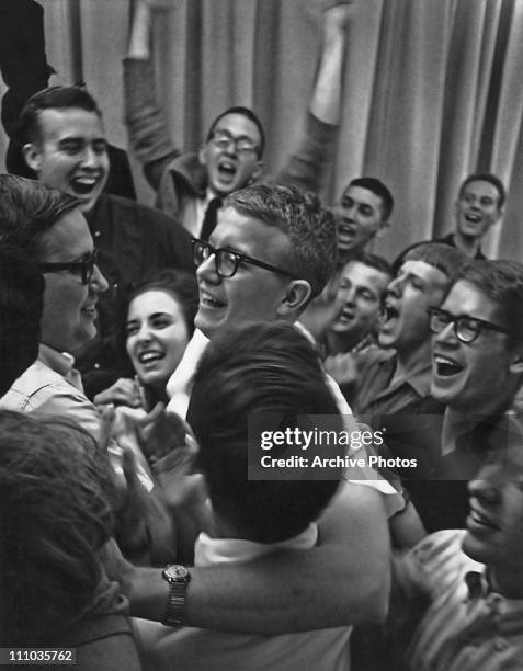 Fellow students congratulate Leo Schrey on his election as President of the student body at the University of Kansas, circa 1960.
