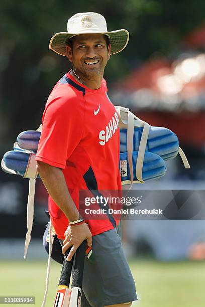 Sachin Tendulkar of India carries his batting kit during an Indian team training session at the PCA ground on March 29, 2011 in Mohali, India. India...