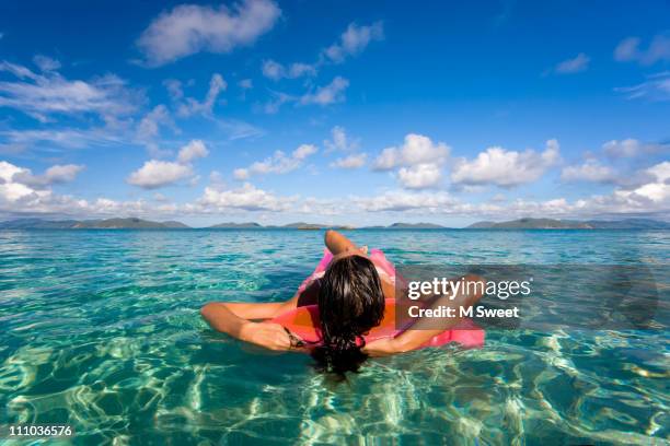 sunbathing woman - luftmatraze stock-fotos und bilder