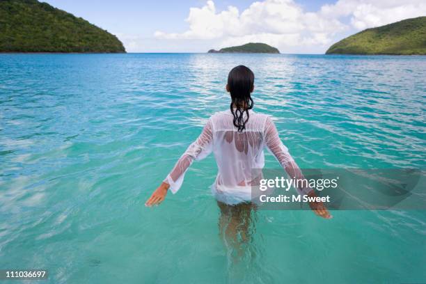 beautiful woman wading in serene water - us virgin islands stock pictures, royalty-free photos & images