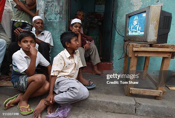 People crowd around the television sets to watch the action as Sri Lanka play New Zealand in the ICC World Cup Semi Final match on March 29, 2011 in...