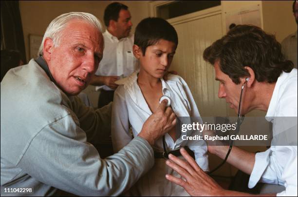 Pr - Deloche and Dr - Cheysson examining children at Dr - Nilab's medical officein Kaboul, Afghanistan on May 27, 2003.