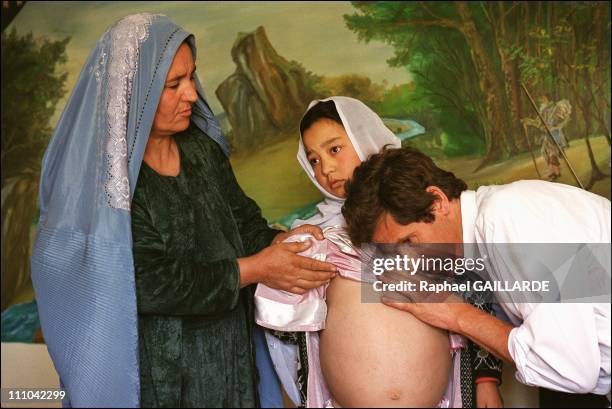 Dr - Cheysson examining a child at Dr - Nilab's medical office - This child is one of those who will be sent to the Paris Pompidou Hospital for a...
