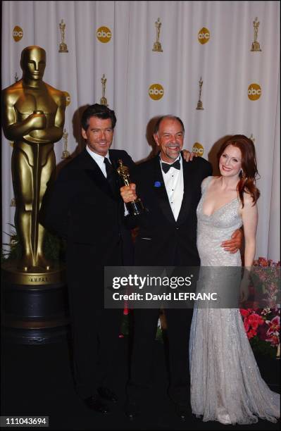 Pierce Brosnan who is dressed by Versace, x, Julianne Moore who is dressed by Versace in Los Angeles, United States on February 29, 2004.