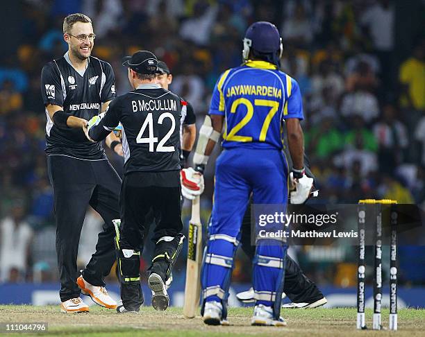 Brendon McCullum of New Zealand congratulates Daniel Vettori on the wicket of Mahela Jayawardena of Sri Lanka, after he was bowled LBW during the...