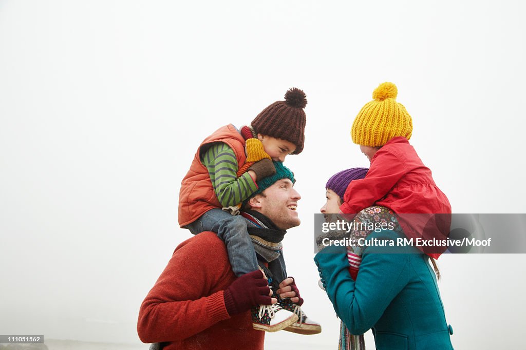 Parents with children on shoulders