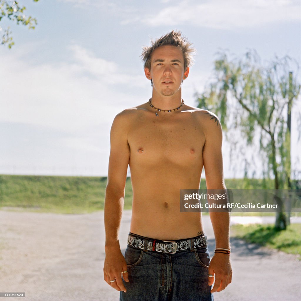 Man standing in sun in caravan park