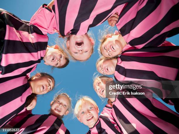 girl soccer players standing in circle - sports team huddle stock pictures, royalty-free photos & images