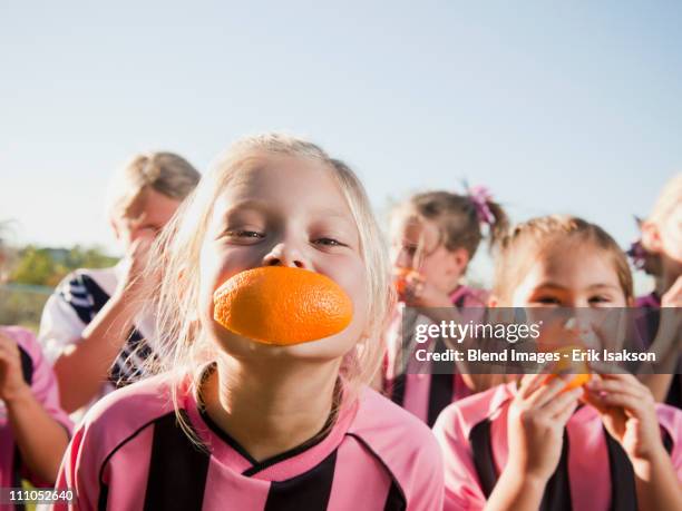 girl soccer players eating orange slices - comic strip bildbanksfoton och bilder