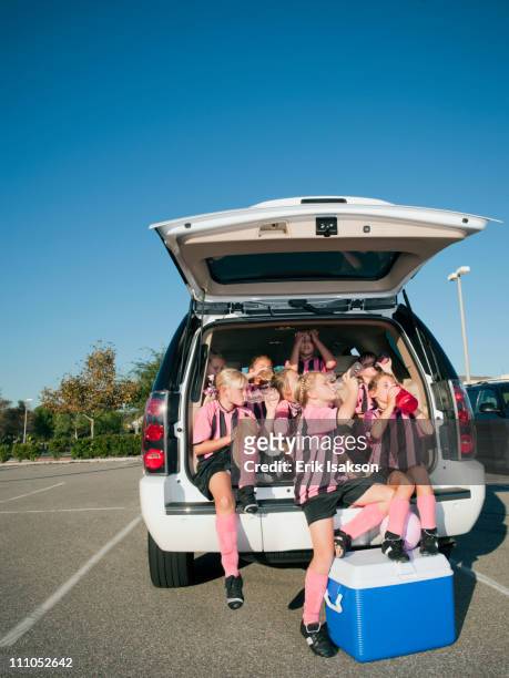 girl soccer players sitting in back of car - soccer team stock pictures, royalty-free photos & images