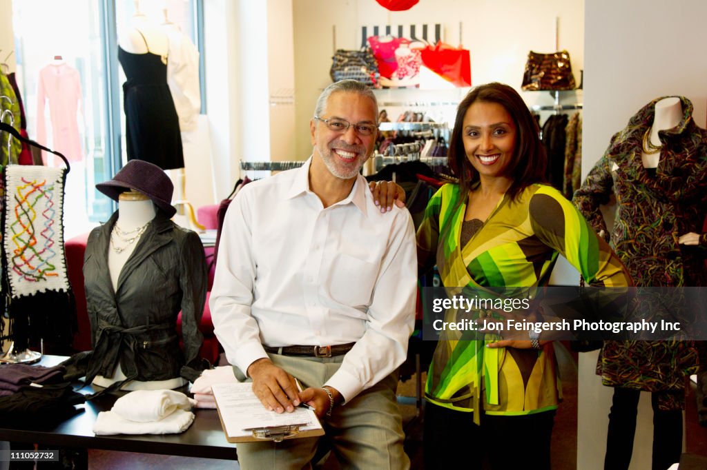 Small business owners standing in clothing shop