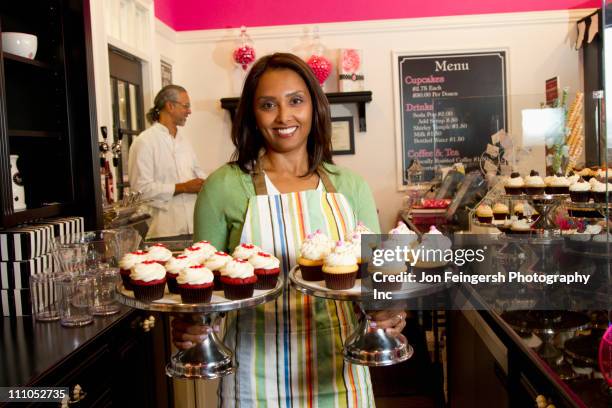 small business owners with cupcakes in bakery shop - indian bakery products stock pictures, royalty-free photos & images