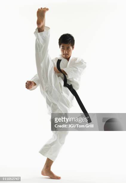asian male karate black belt kicking in air - 空手　蹴る　not子供 ストックフォトと画像