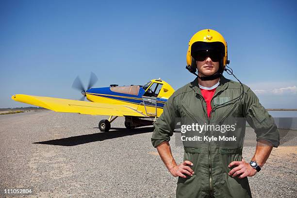 pilot standing near small airplane - propeller airplane stock pictures, royalty-free photos & images