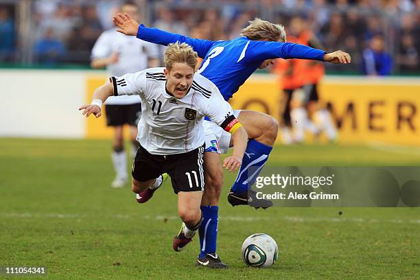 Lewis Holtby of Germany is challenged by Alessandro Crescenzi of Italy during the U21 international friendly match between Germany and Italy at...