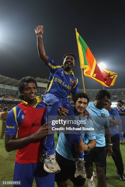 Muttiah Muralitharan of Sri Lanka is hoisted high by Dilhara Fernando and physio Tommy Simisek after the five wicket victory and Muralitharan's last...