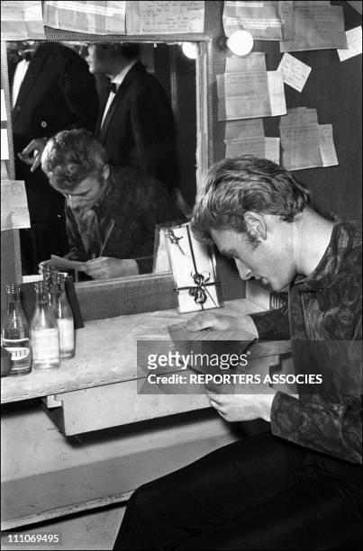 Johnny Hallyday in the sixties in France - Premiere of Johnny Hallyday show, Johnny reading a telegram in France on February 07, 1964.