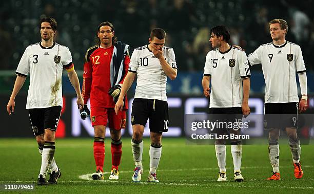 Arne Friedrich, goalkeeper Tim Wiese, Lukas Podolski, Christian Traesch and Andre Schuerrle of Germany are looking dejected after loosing the...