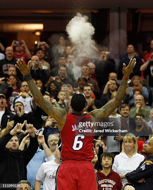 LeBron James of the Miami Heat performs his pre-game chalk throw ritual before the game against the Cleveland Cavaliers on March 29, 2011 at Quicken...