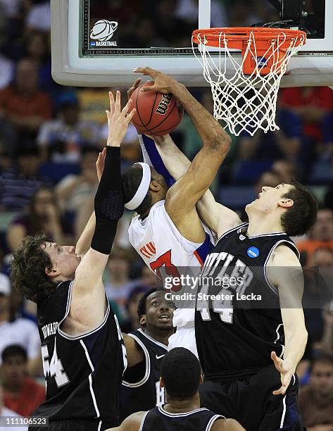 Alex Tyus of the Florida Gators has his shot blocked by Andrew Smith and Matt Howard of the Butler Bulldogs during the Southeast regional final of...