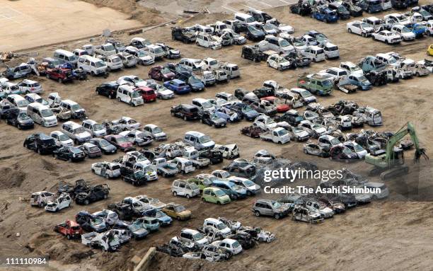 In this aerial image, destroyed cars by the earthquake and the tsuanmi are arranged on March 25, 2011 in Miyako, Iwate, Japan. More than three weeks...