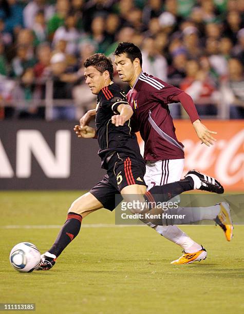 Ricardo Osorio of Mexico dribbles the ball against Nicolas Fedor of Venezuela during the first half of the exhibition game at Qualcomm Stadium on...