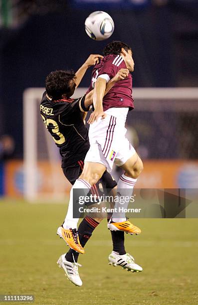 Luis Perez of Mexico fights for control of the ball against Nicolas Fedor of Venezuela during the first half of the exhibition game at Qualcomm...