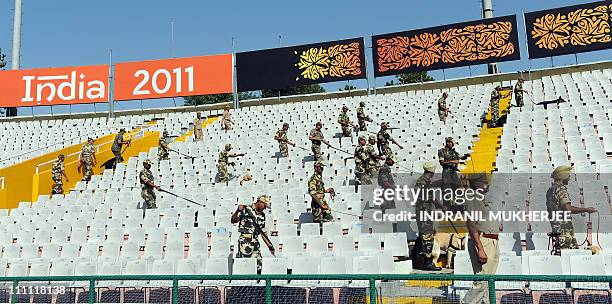 Central Reserve Police Force bomb-squad officials search the empty stadium with sniffer dogs prior to the start of the ICC Cricket World Cup 2011...