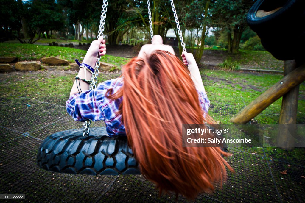 Girl swinging in park