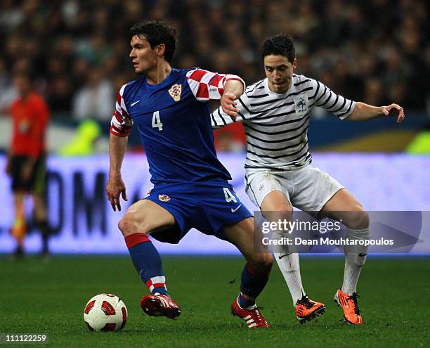 Samir Nasri of France chases Dejan Lovren of Croatia during the International friendly match between France and Croatia at Stade de France on March...