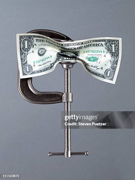 us one dollar bill being crushed in a vise - vice grip stock pictures, royalty-free photos & images