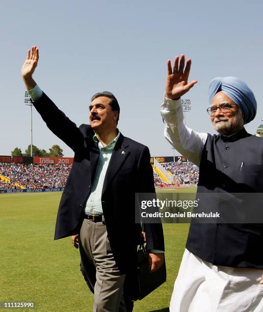 Prime Minister Syed Yusuf Raza Gilani of Pakistan and Prime Minister Manmohan Singh of India wave to spectators prior to the start of the 2011 ICC...